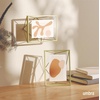 image:imageUmbra Prisma Picture Frame Floating Metal Wall Mount 5x7 Brass  Steel wire construction unique geometric shape displays photo between glass desk or tabletop use hardware includedBrass