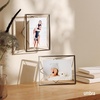 image:imageUmbra Prisma Picture Frame Floating Metal Wall Mount 5x7 Brass  Steel wire construction unique geometric shape displays photo between glass desk or tabletop use hardware includedChrome