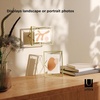 image:imageUmbra Prisma Picture Frame Floating Metal Wall Mount 5x7 Brass  Steel wire construction unique geometric shape displays photo between glass desk or tabletop use hardware includedBrass