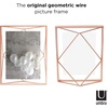 image:imageUmbra Prisma Picture Frame Floating Metal Wall Mount 5x7 Brass  Steel wire construction unique geometric shape displays photo between glass desk or tabletop use hardware includedCopper