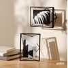 image:imageUmbra Prisma Picture Frame Floating Metal Wall Mount 5x7 Brass  Steel wire construction unique geometric shape displays photo between glass desk or tabletop use hardware includedBlack