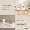 image:imageUmbra Prisma Picture Frame Floating Metal Wall Mount 5x7 Brass  Steel wire construction unique geometric shape displays photo between glass desk or tabletop use hardware includedBrass