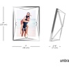 image:imageUmbra Prisma Picture Frame Floating Metal Wall Mount 5x7 Brass  Steel wire construction unique geometric shape displays photo between glass desk or tabletop use hardware includedChrome