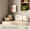 image:imageUmbra Prisma Picture Frame Floating Metal Wall Mount 5x7 Brass  Steel wire construction unique geometric shape displays photo between glass desk or tabletop use hardware includedBrass