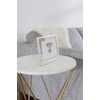 image:imageUmbra Prisma Picture Frame Floating Metal Wall Mount 5x7 Brass  Steel wire construction unique geometric shape displays photo between glass desk or tabletop use hardware includedBrass