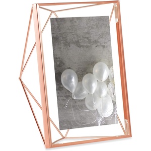 image:imageUmbra Prisma Picture Frame Floating Metal Wall Mount 5x7 Brass  Steel wire construction unique geometric shape displays photo between glass desk or tabletop use hardware includedCopper